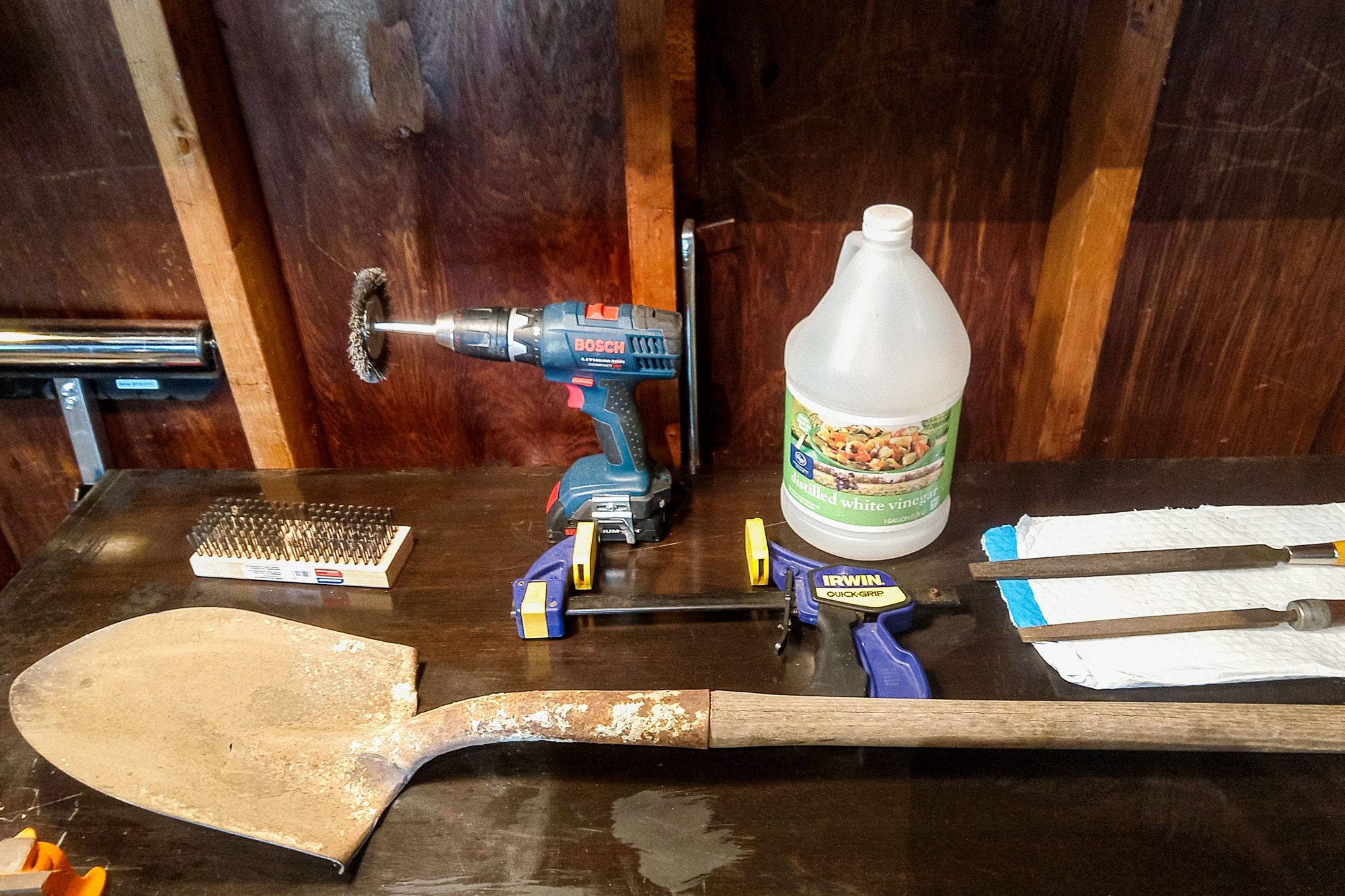 Edger and Sharpening Tools laid out on Wooden Surface