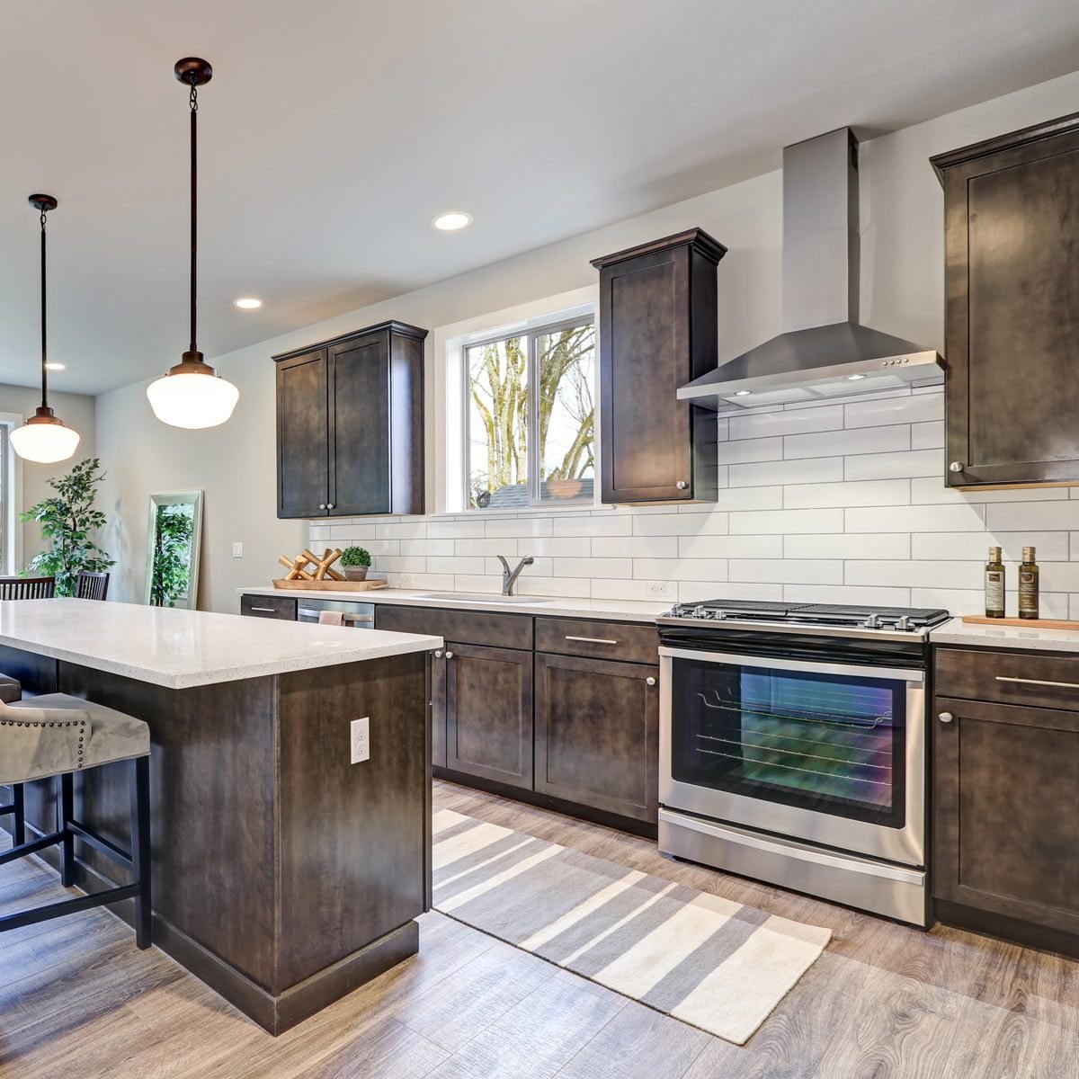 Best Kitchen Backsplash Ideas For Dark Cabinets Family Handyman   New Kitchen Boasts Dark Wood Cabinets White Backsplash Subway Tile And Over Sized Island With White And Grey Quartz Counter Illuminated By Pendant Lights Shutterstock 578770597 1 