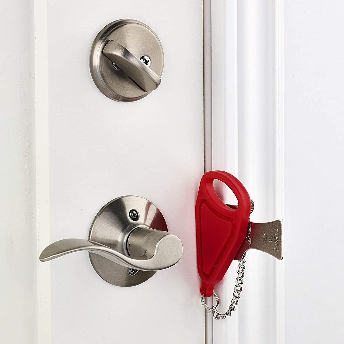 A locked metal door hook on white wooden door, simple device for home house  safety and protection Stock Photo