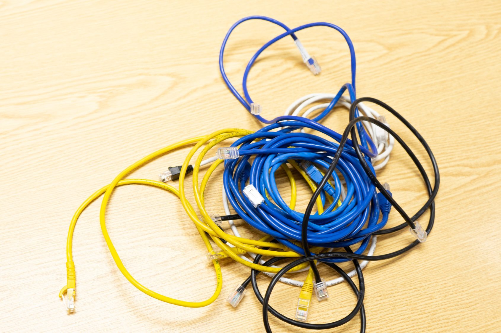 Close-Up Of Tangled Cables On Table