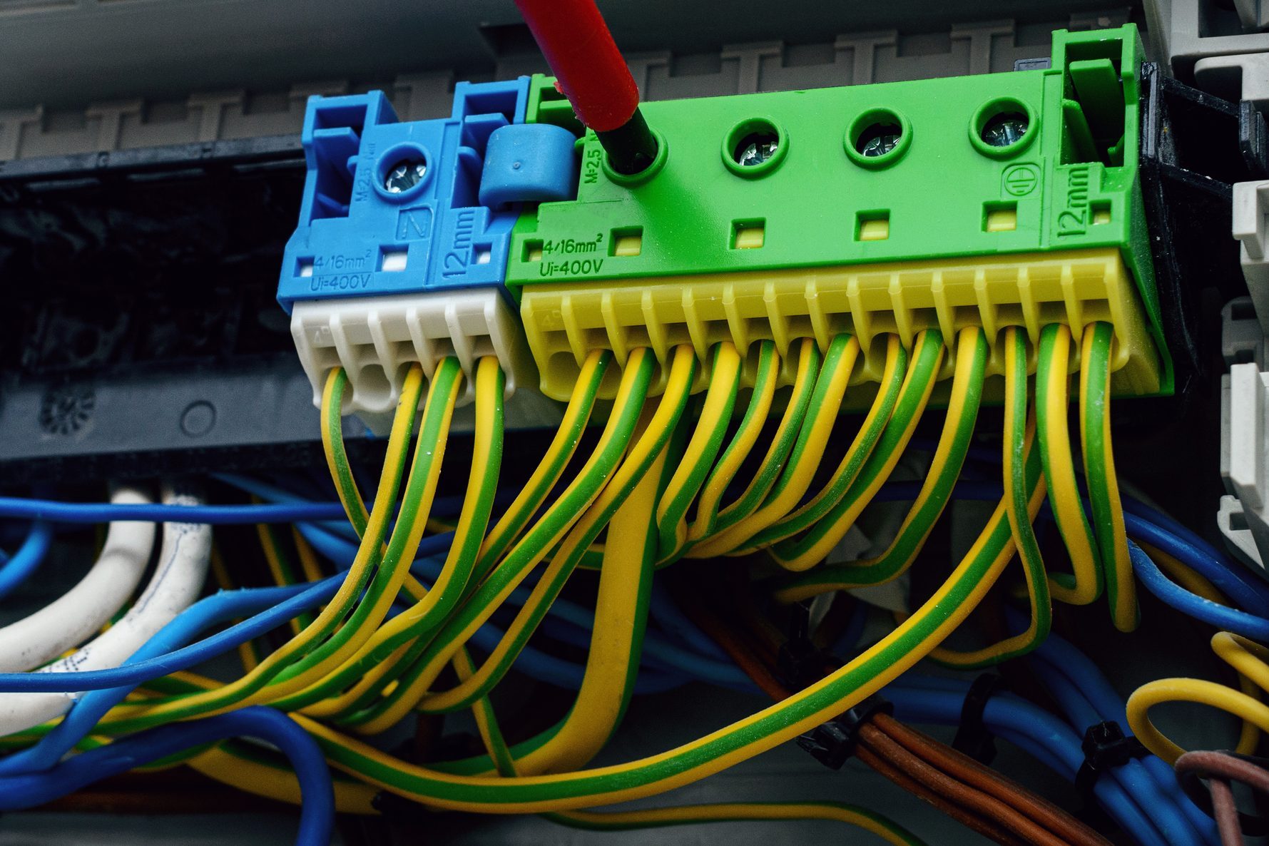 Worker connecting some ground wires, pad grounding