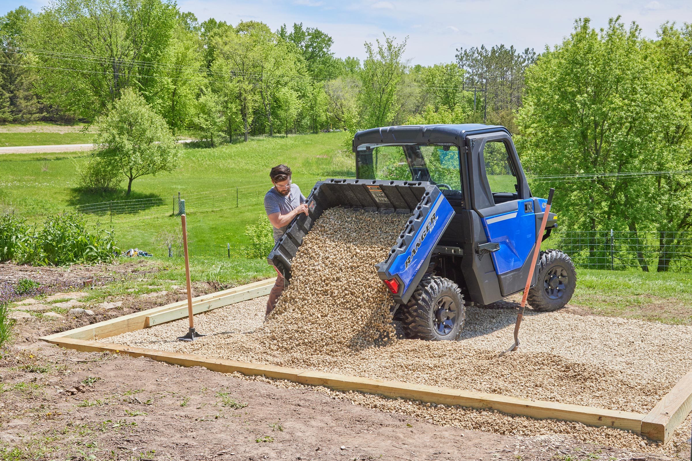 pouring gravel to build the greenhouse foundation