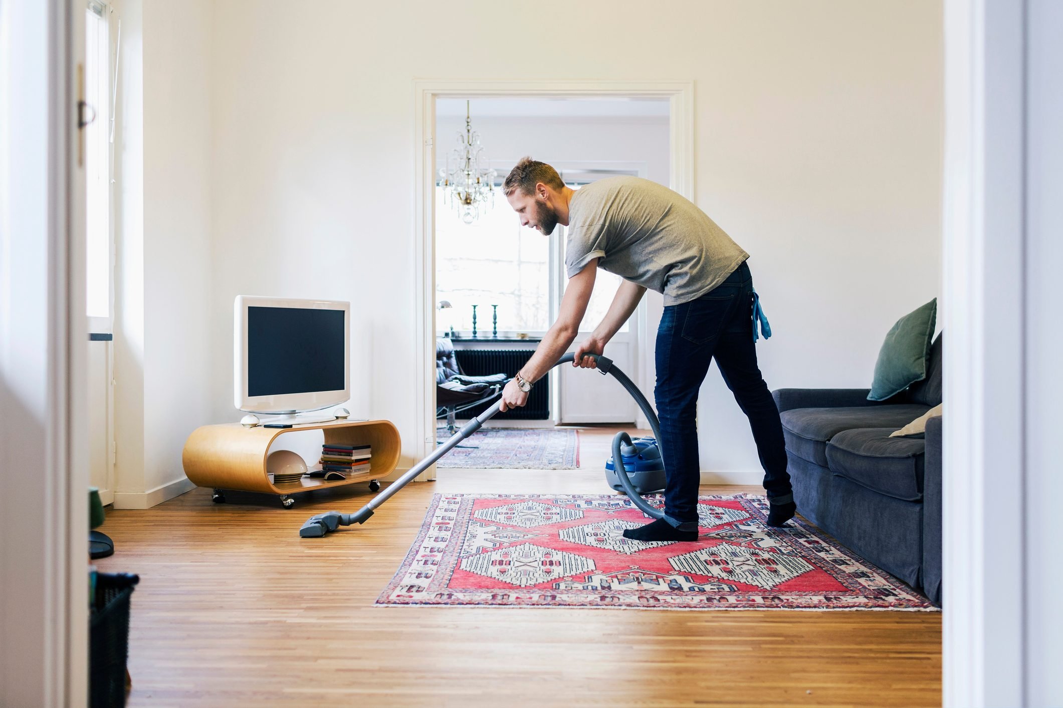 A man vacuuming his home