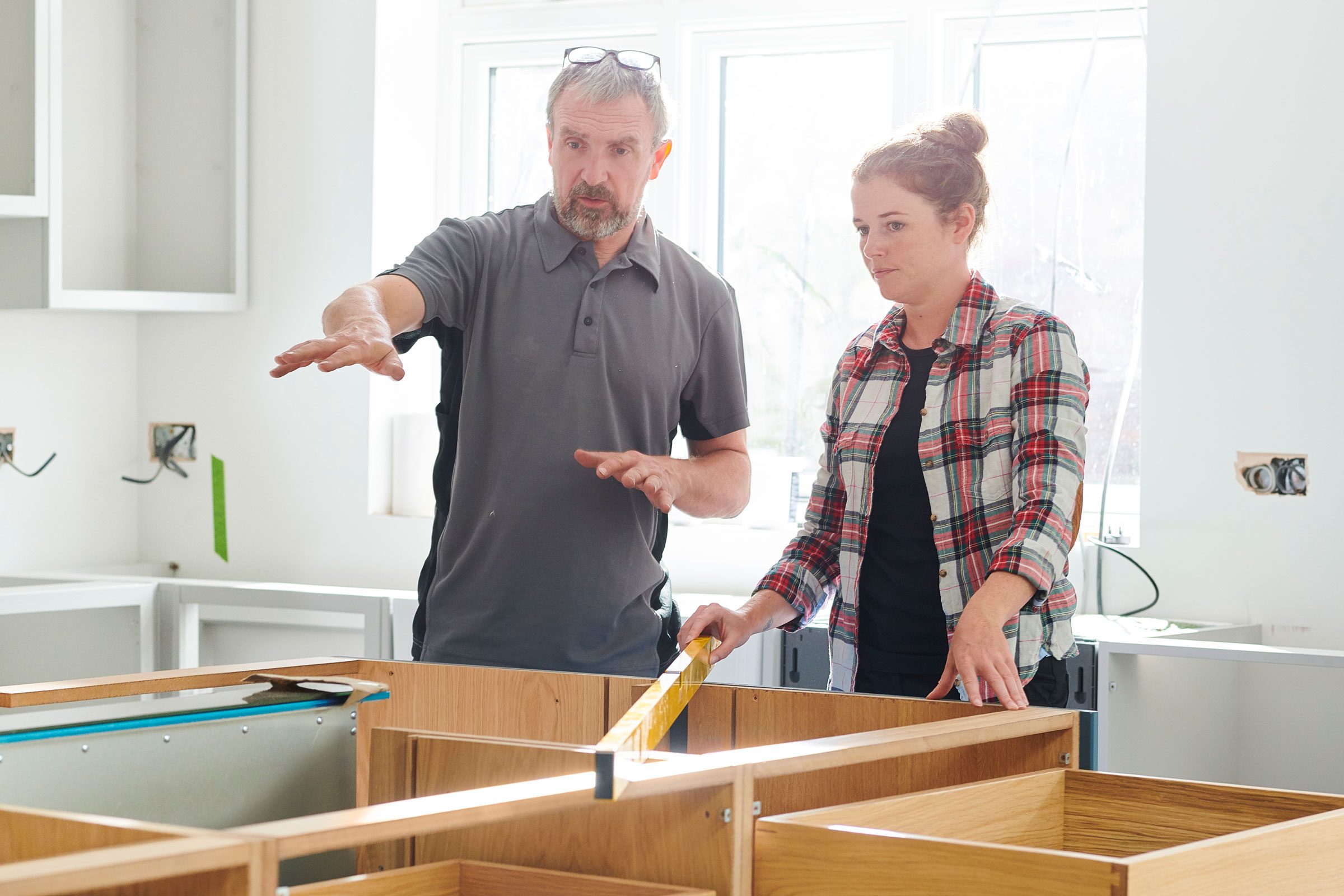 Homeowner And Contractor talking In A Kitchen Remodel