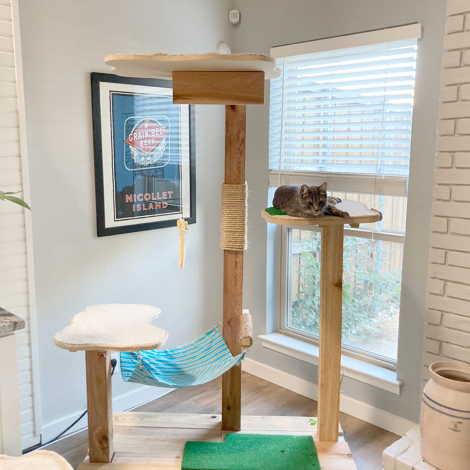 https://www.familyhandyman.com/wp-content/uploads/2022/12/DIY-Cat-Tree-and-TowerCat-tree-finished-w-cat-Ally-Childress-for-FHM-JVedit.jpg