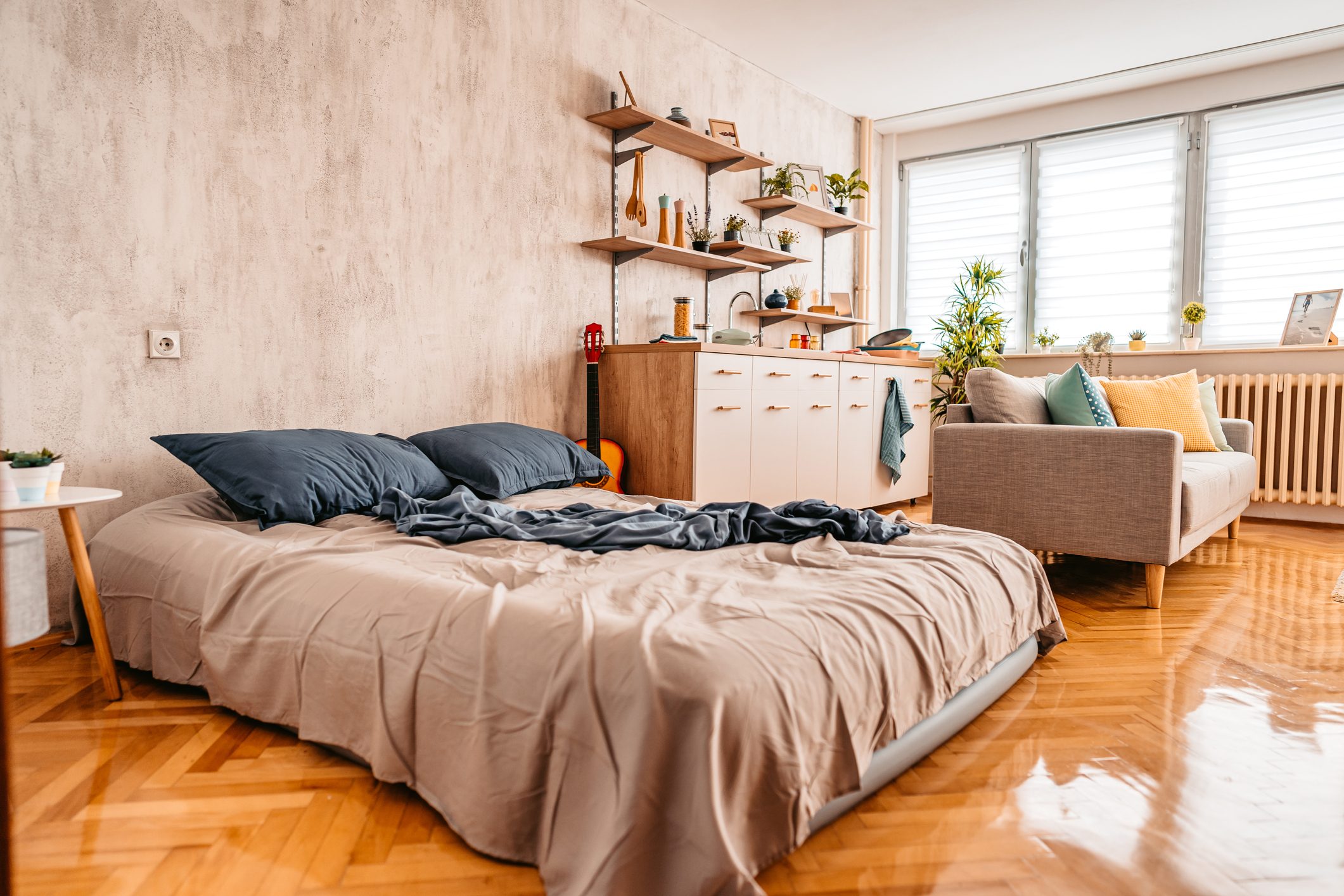 Messy bed in studio apartment