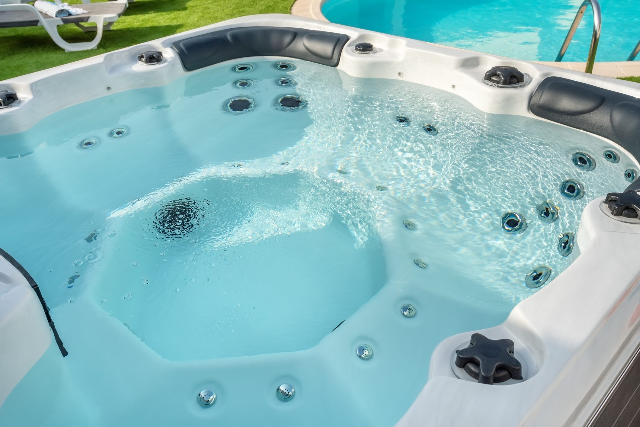 Luxury bathtub, for therapeutic massage and relaxation outside on the grass. Under the blue sky.