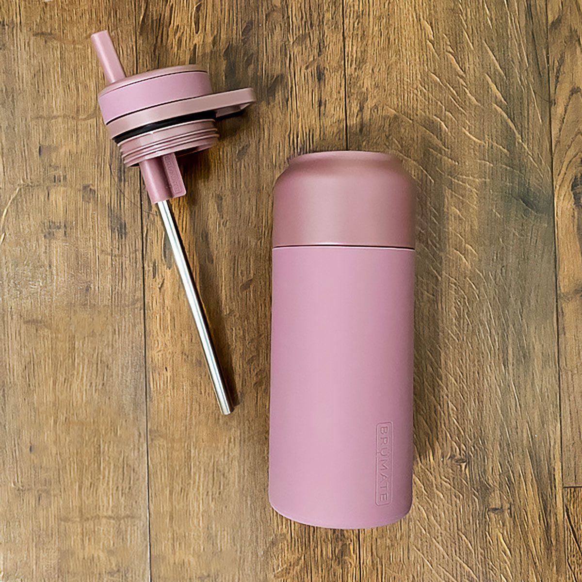 Brumate Rotera Water Bottle with Tumbler on Wooden Surface