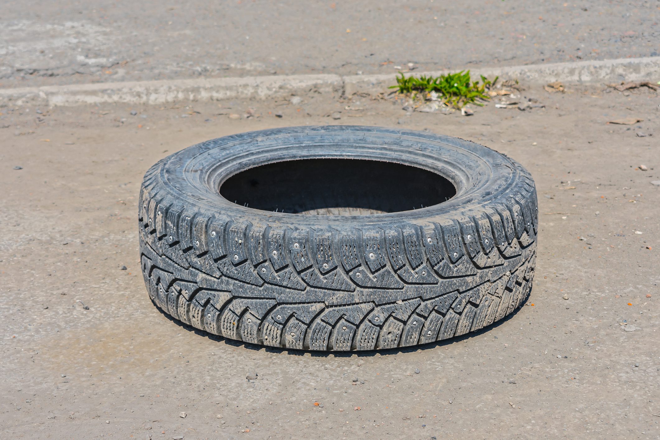 A worn-out winter tire thrown onto the road