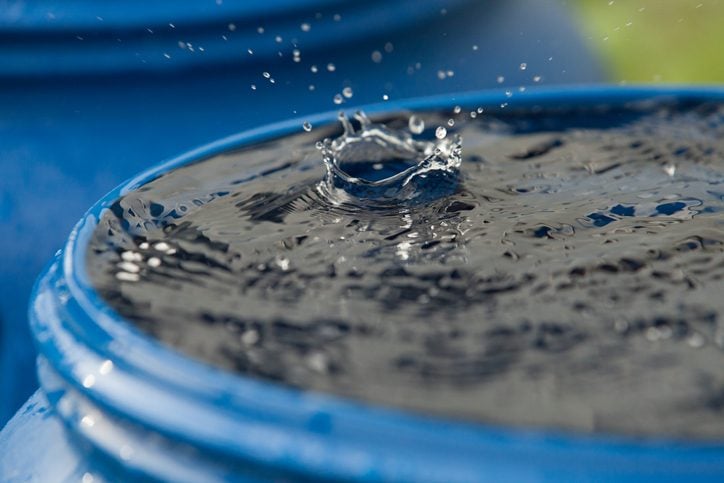 a raindrop breaks into rain tank barrel