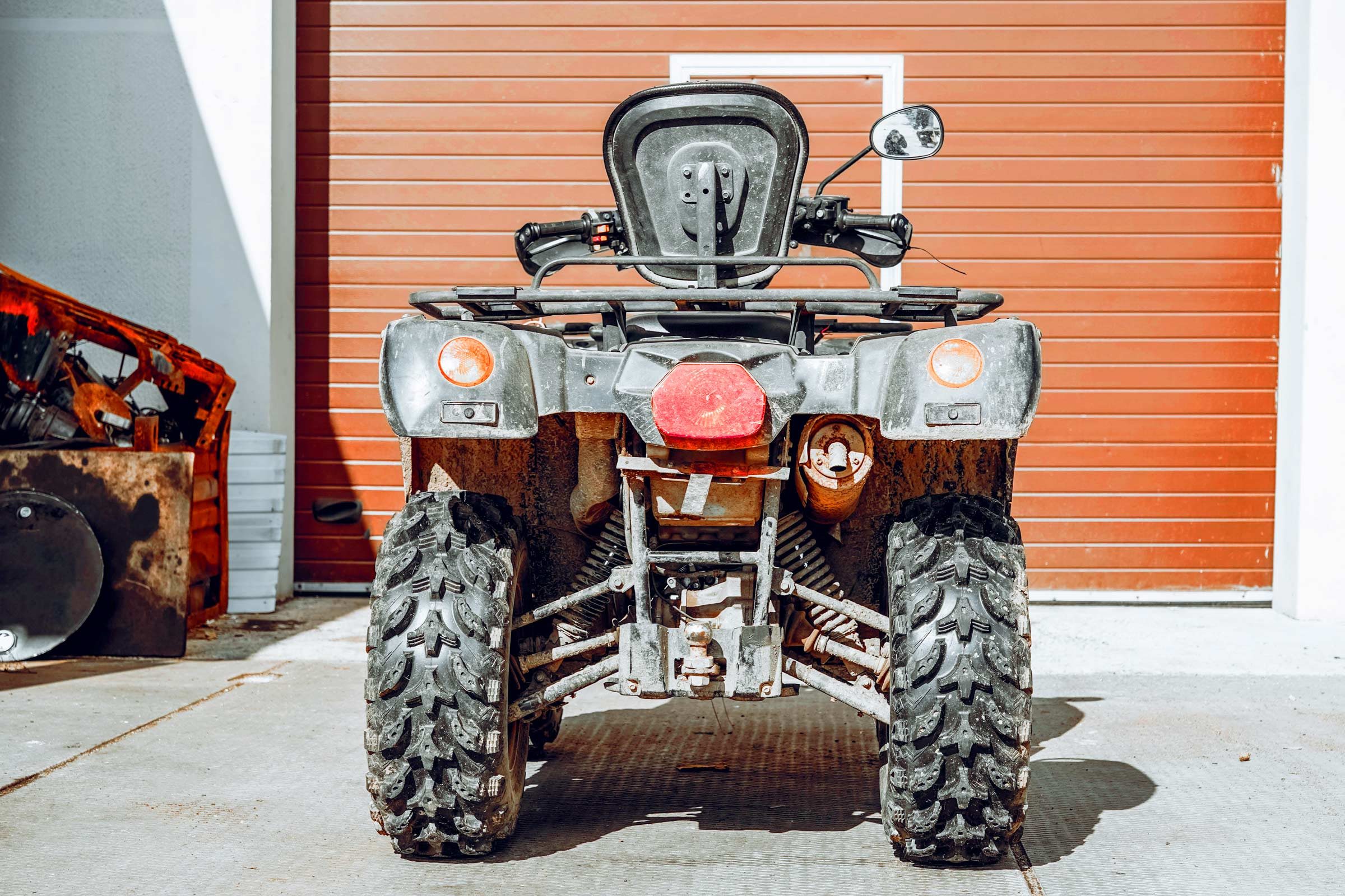 Atv outside a garage