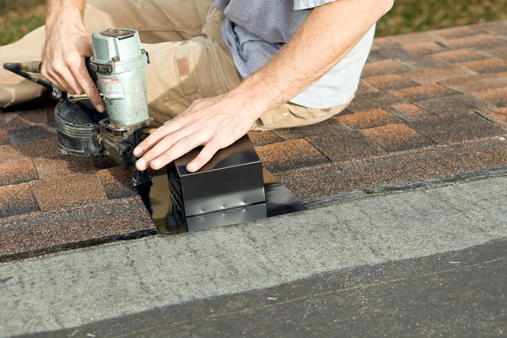 Roofer Nailing Bathroom Vent to New Roof