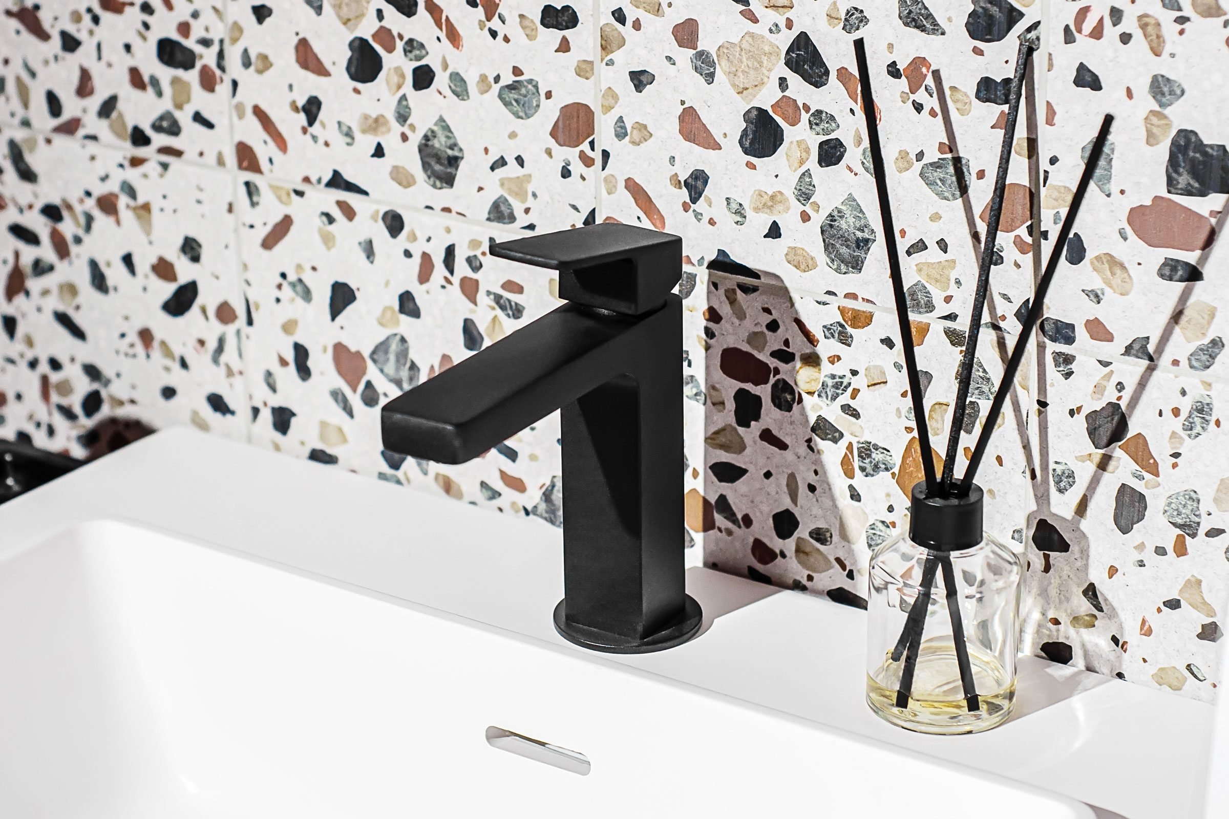 Black Bathroom Sink Faucet with colorful mosaic backsplash