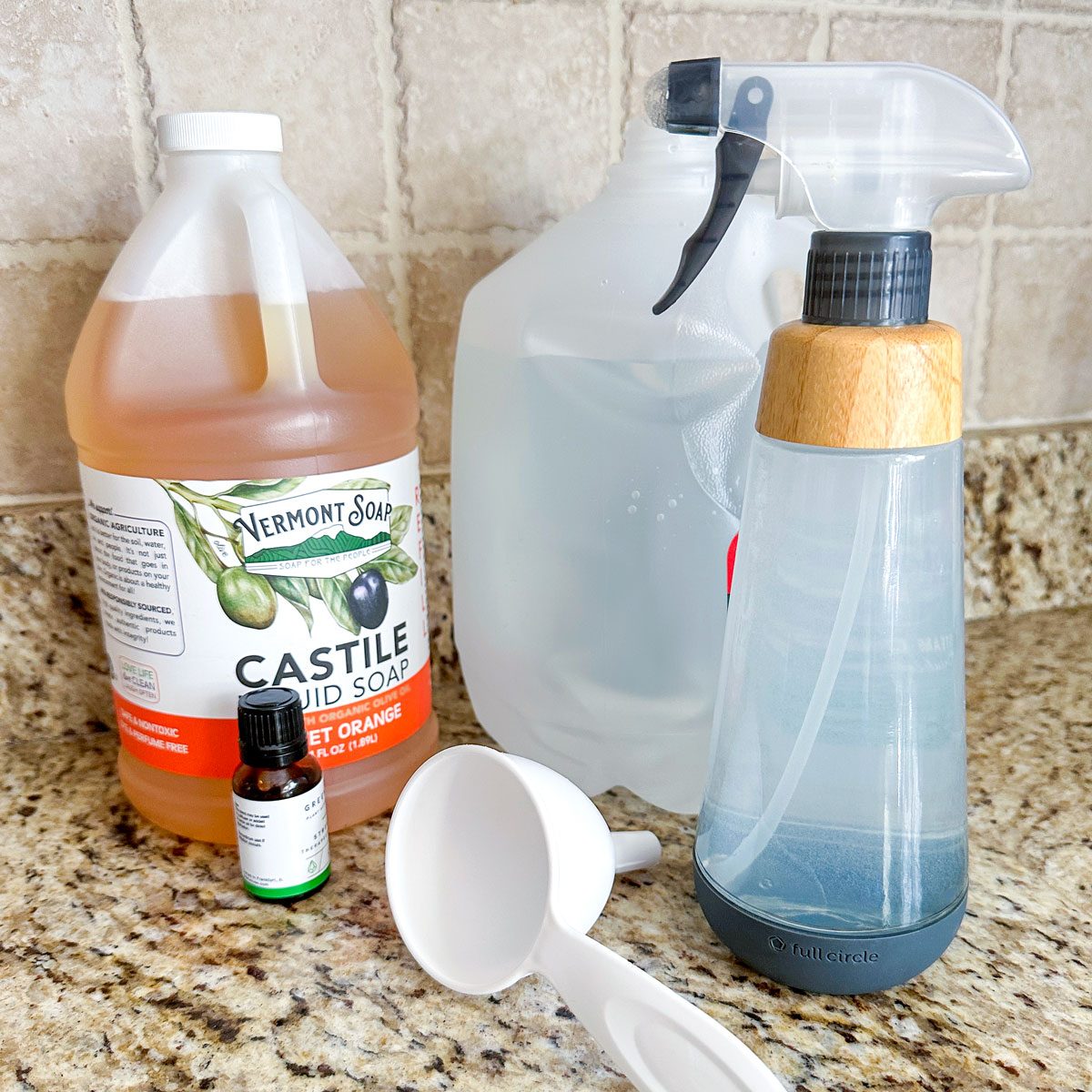 Diy All Purpose Cleaner Spray, Liquid Soap Bottle, Spray bottle, distilled water bottle and Plastic Funnel on Kitchen Countertop