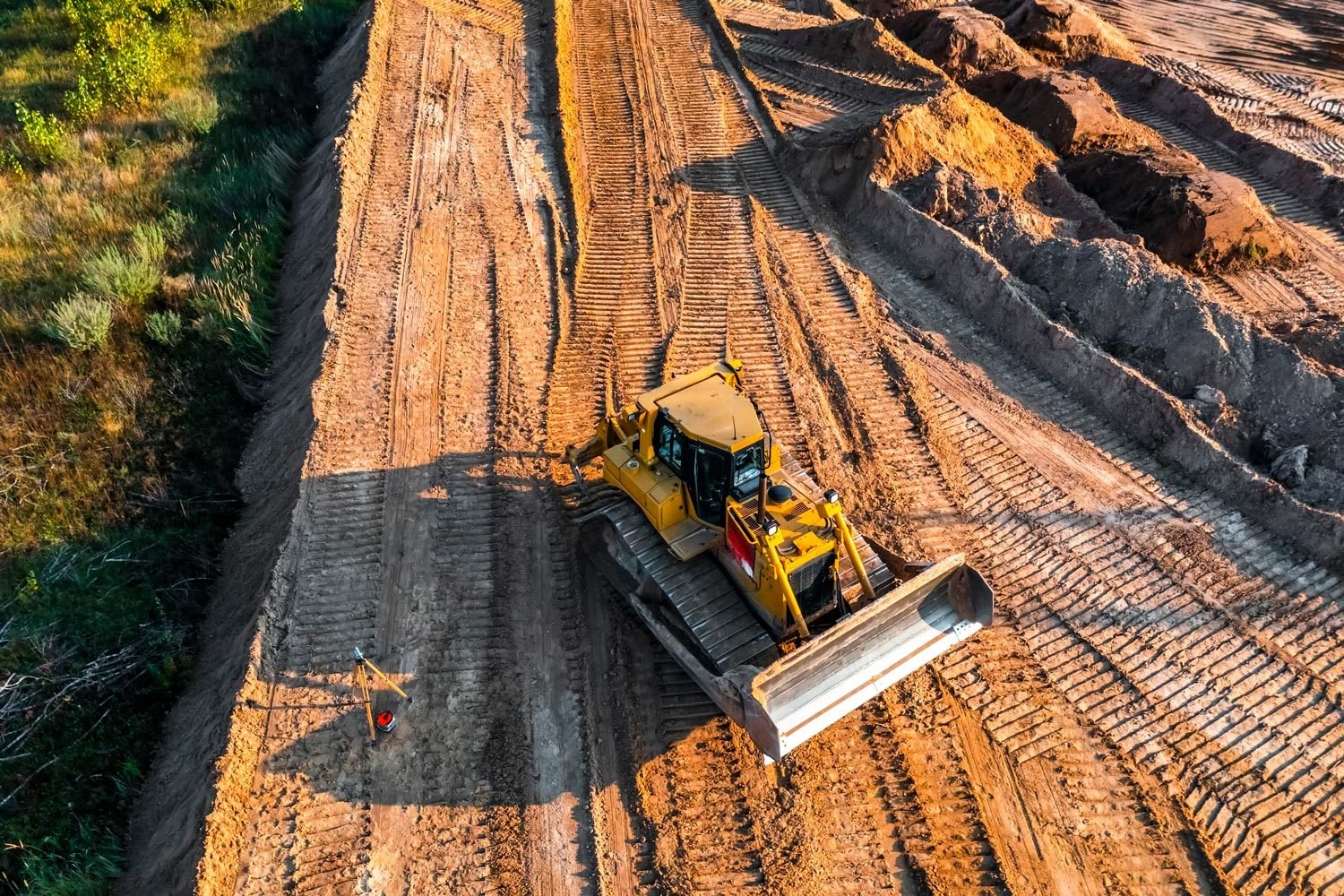 Aerial View of Bulldozer Is Leveling The Ground At The Construction Site