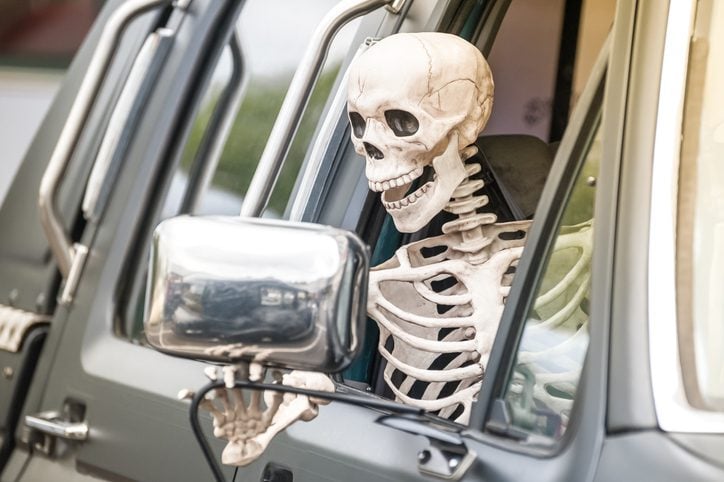 Human Skeleton Halloween Decoration Hanging out of Window of a Truck