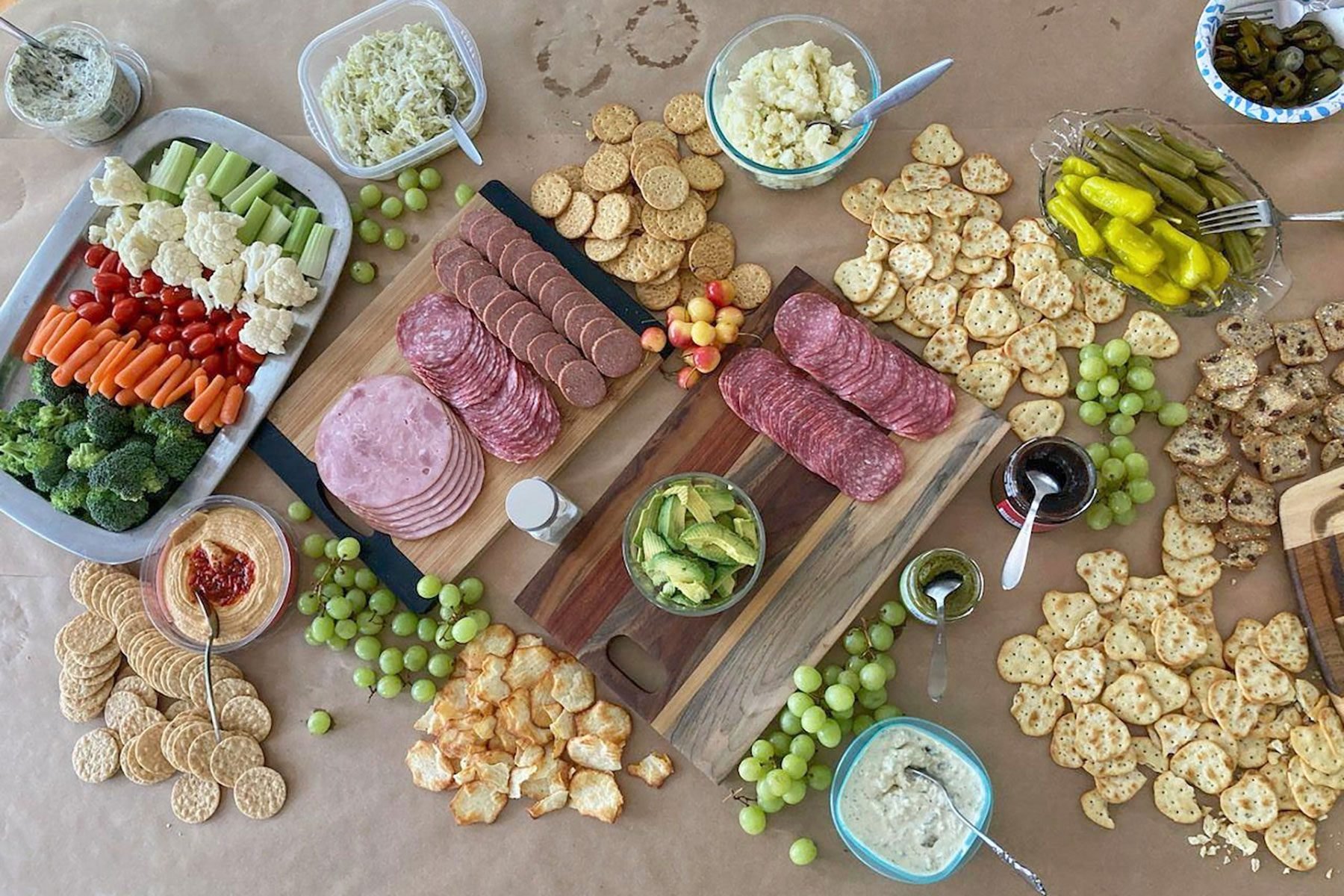 A table with a variety of snacks and crackers.