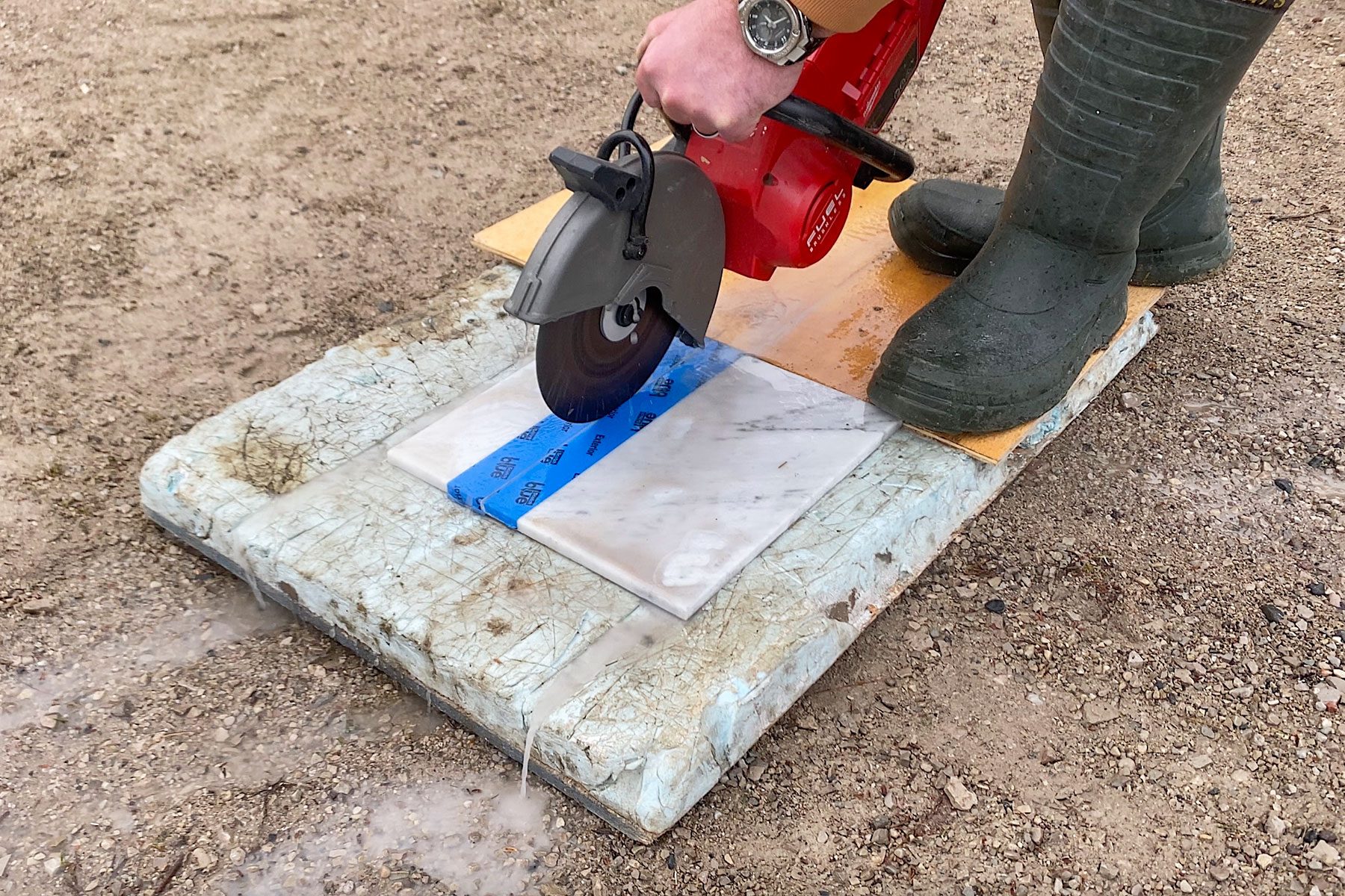 Cutting the marble on ground with saw