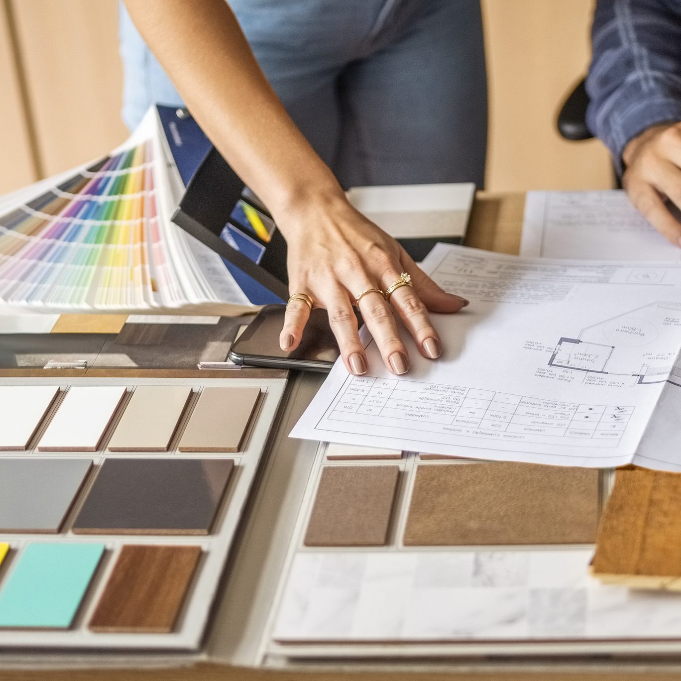 Close-up of a architect discussing building blueprints with female colleague in office