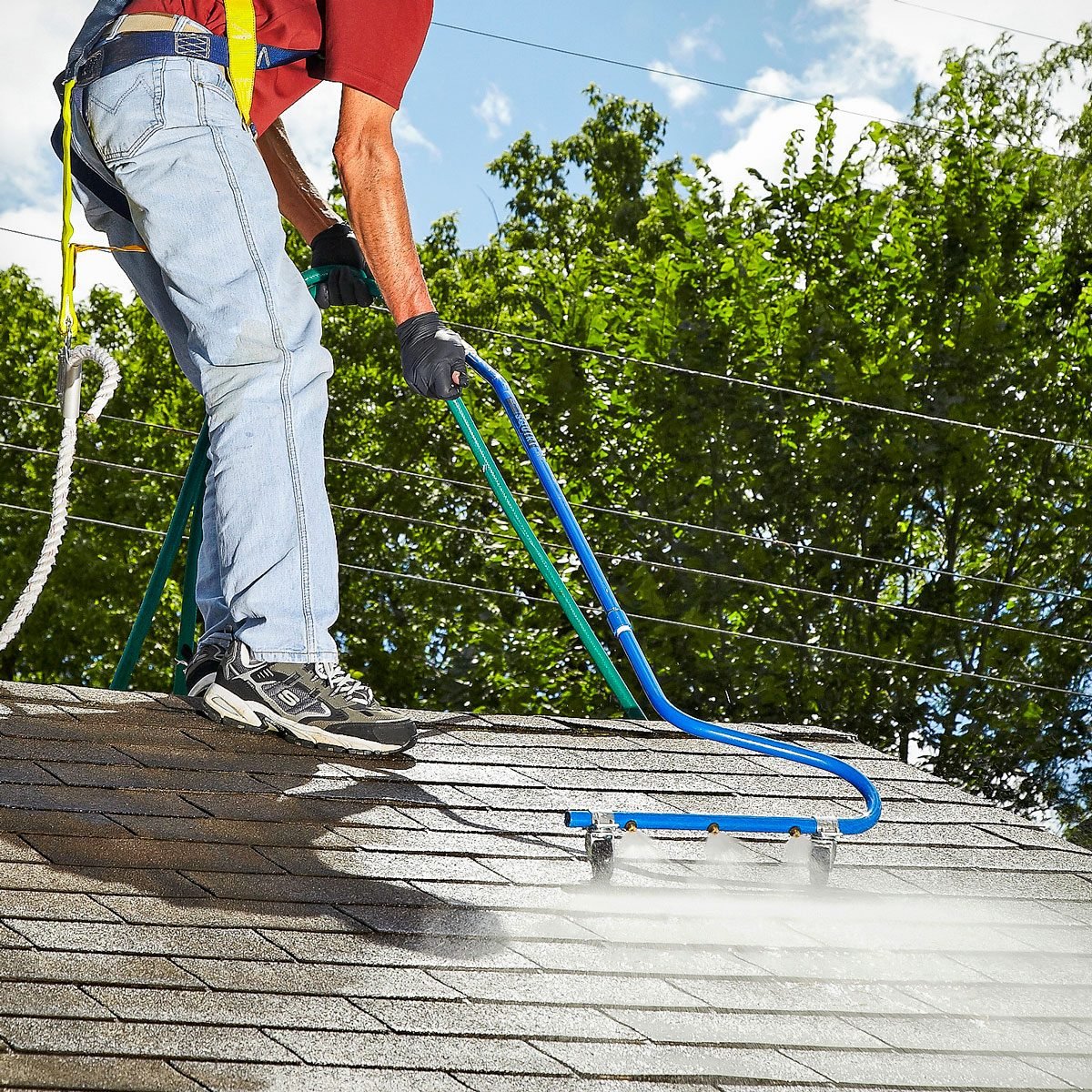 a person cleaning roof stains