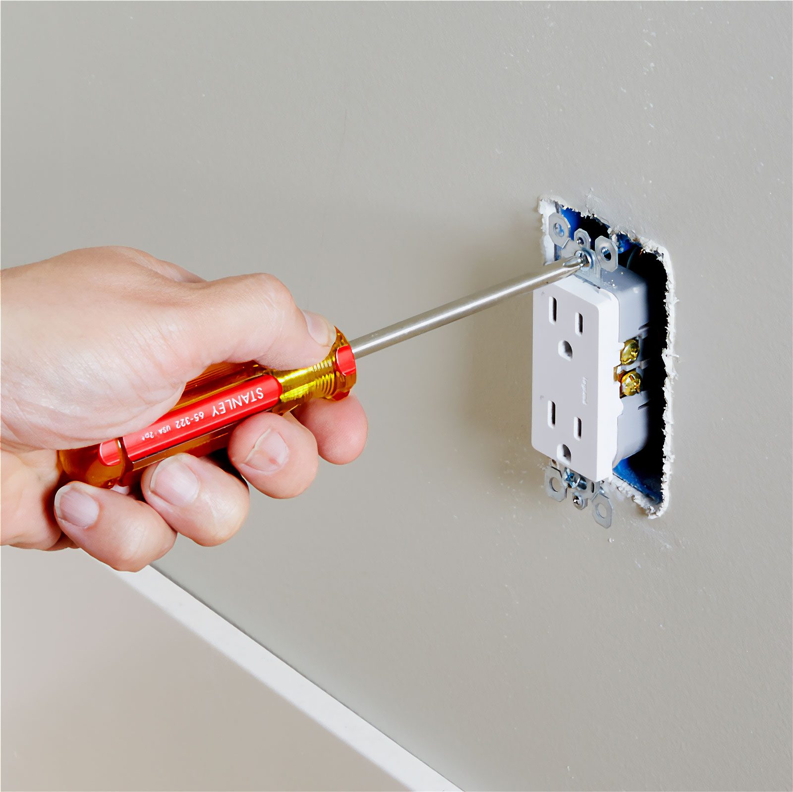 working on installing an outlet on a wall