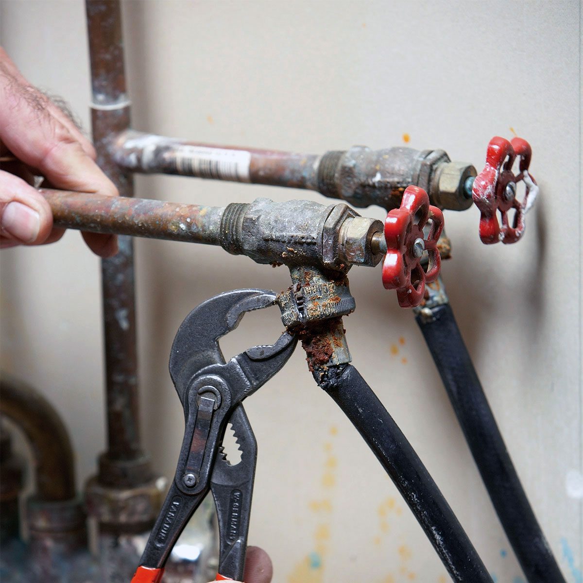 Unscrewing the fittings with pipe wrench