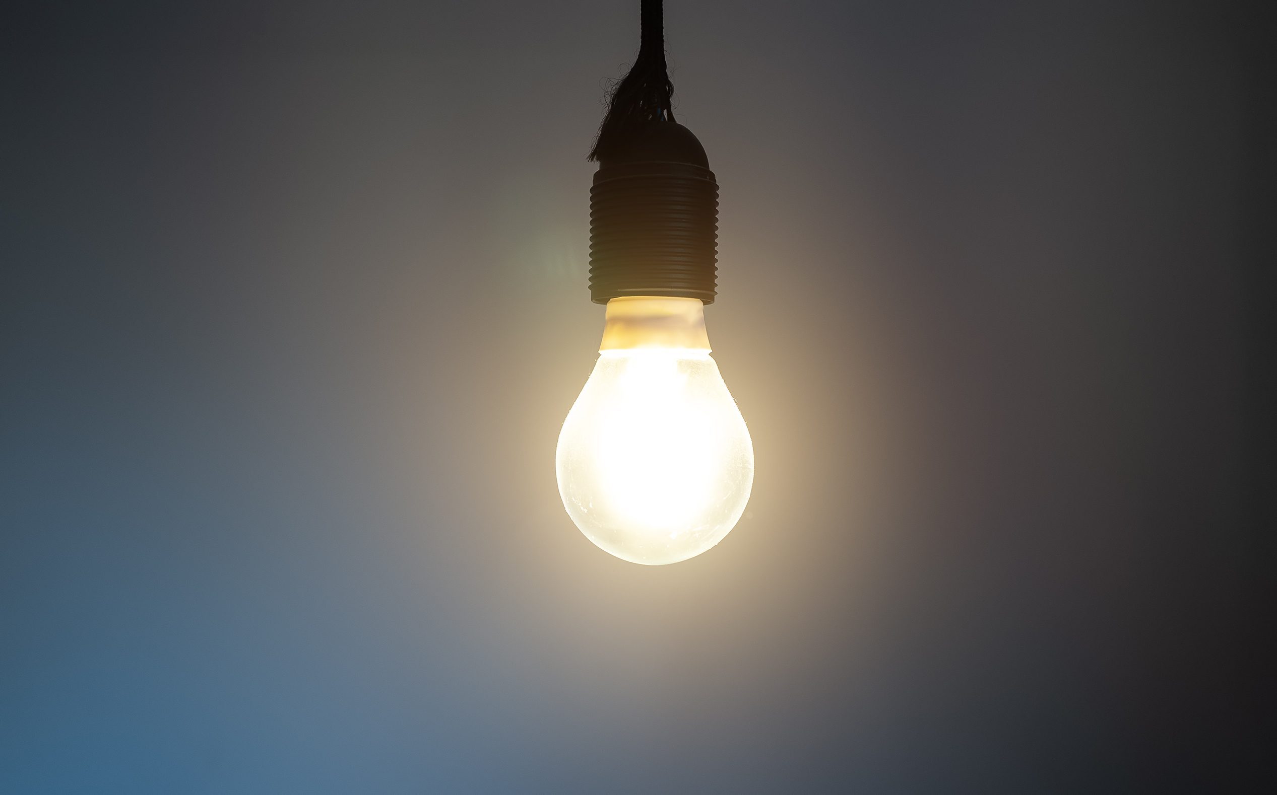 Lit Incandescent light bulb with a medium-sized E27.