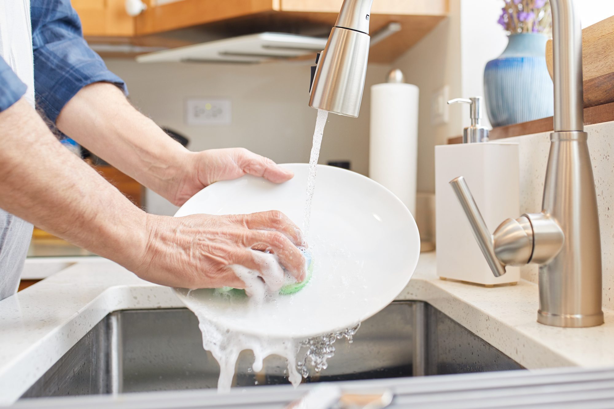 Washing the dishes over the kitchen sink