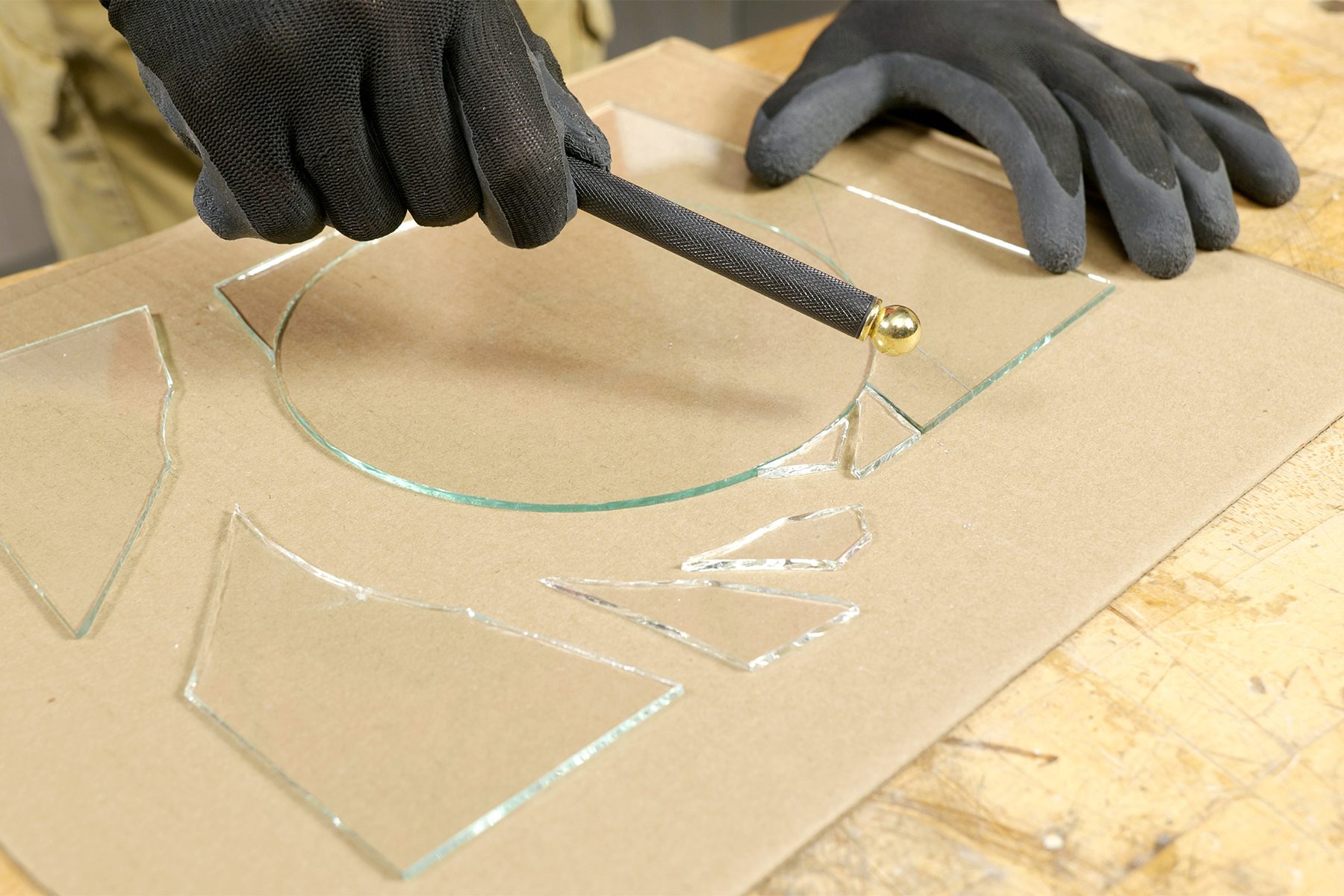 Breaking the extra glass with pencil glass cutter