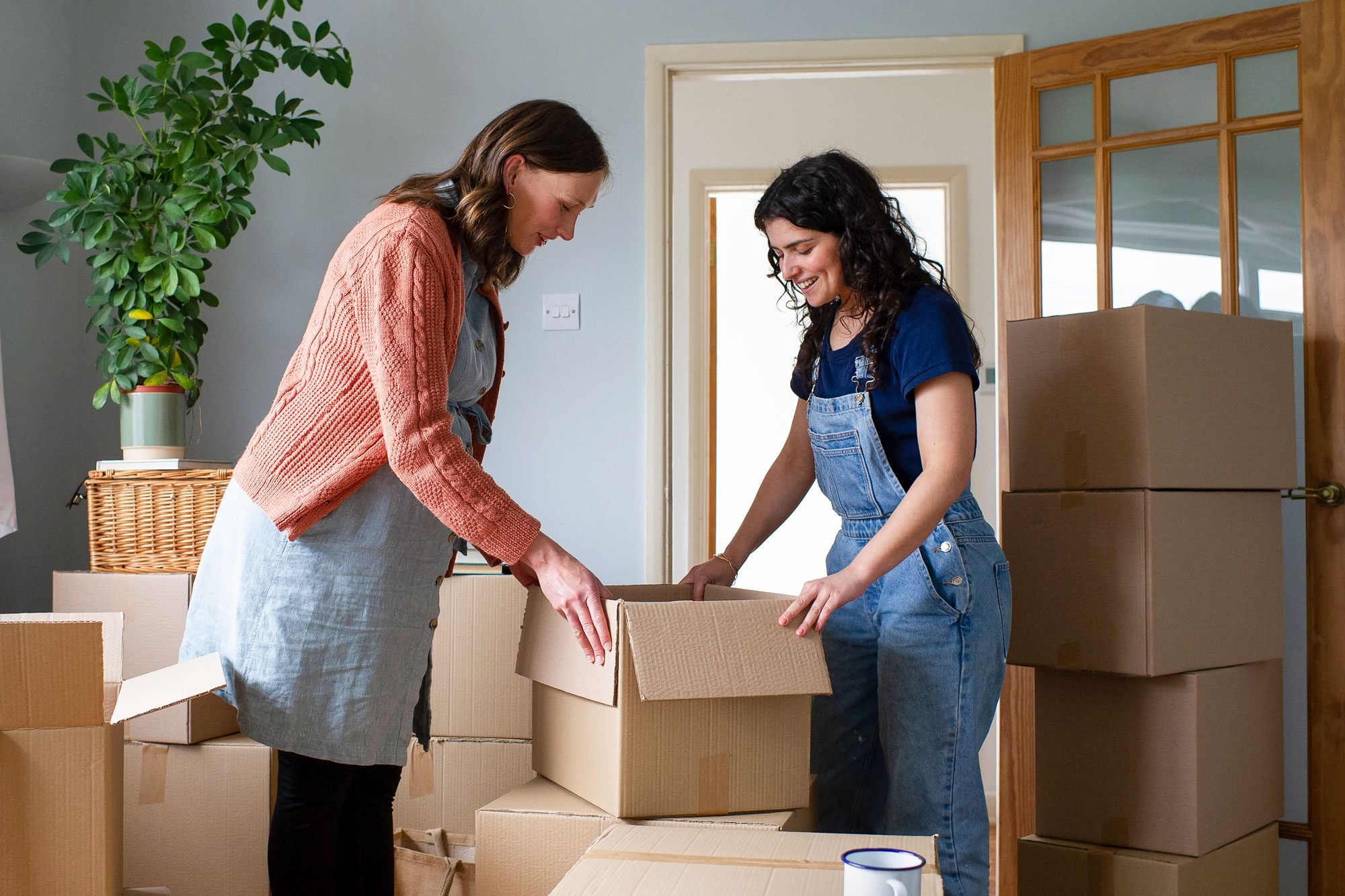 A Female Couple Working Together Moving House