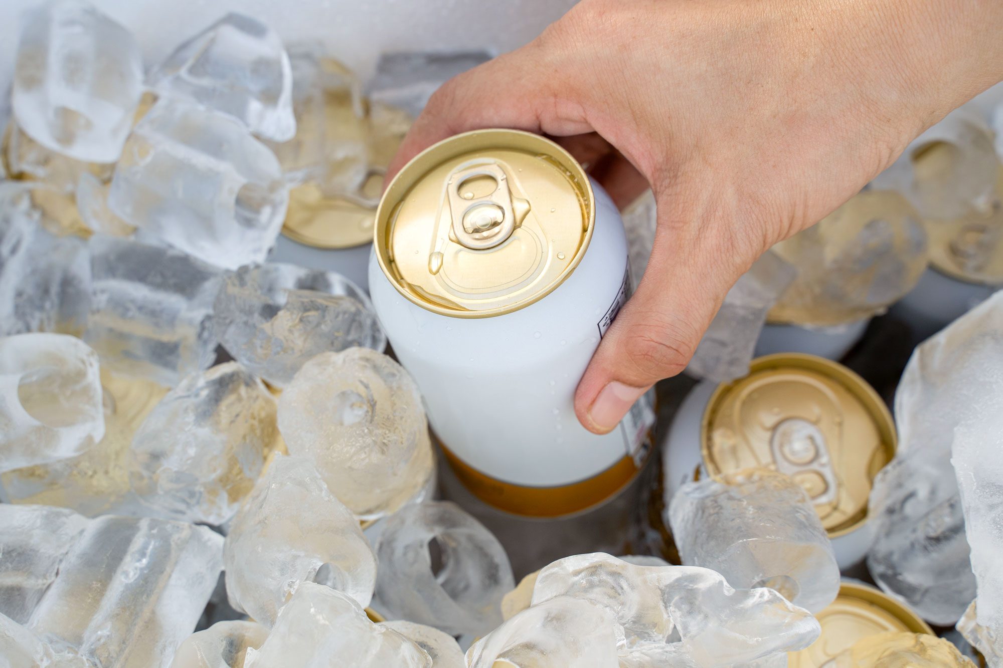 Cold Cans Inside A Cooler Filled With Ice