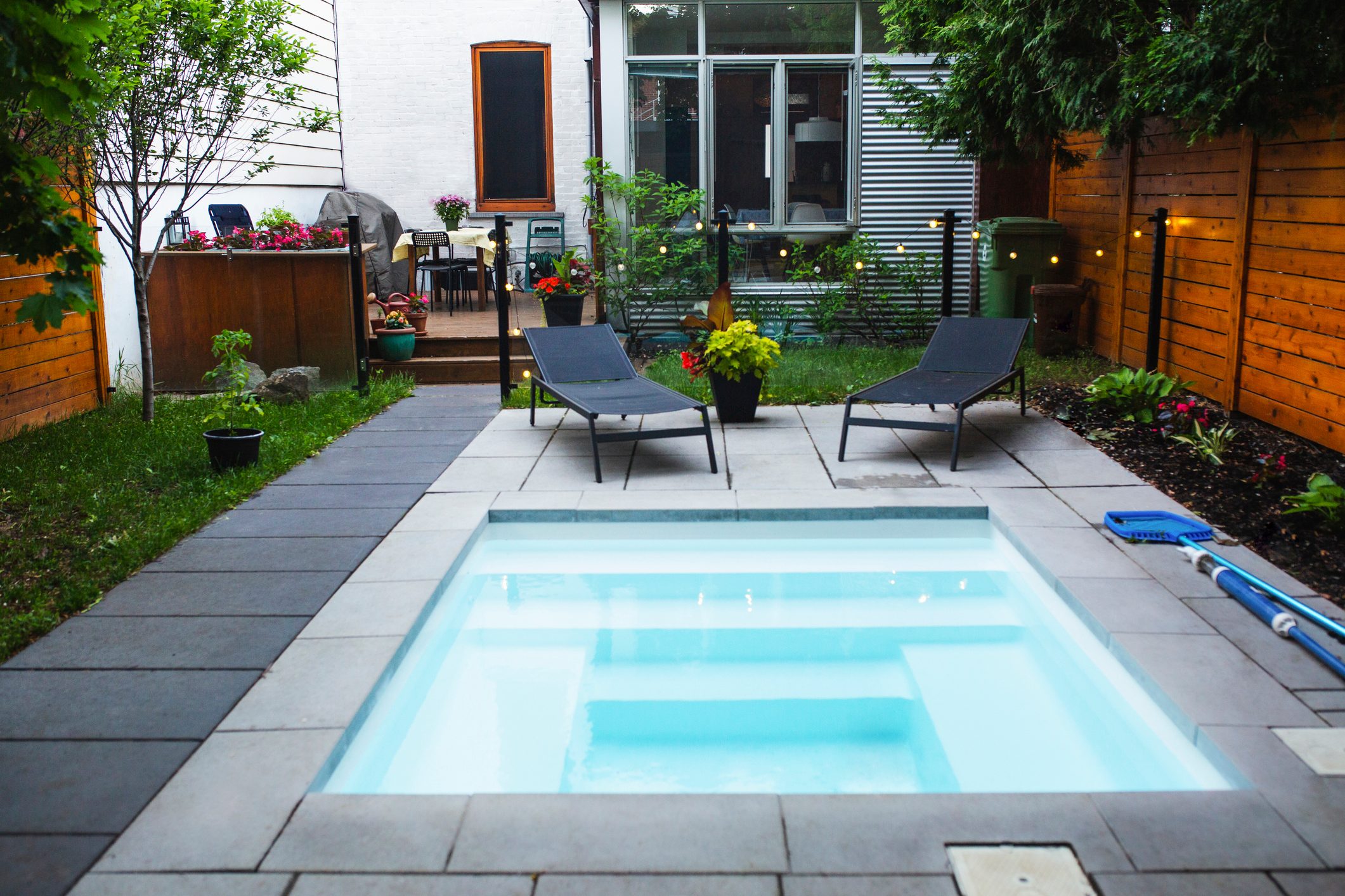 Back yard with a small swimming pool