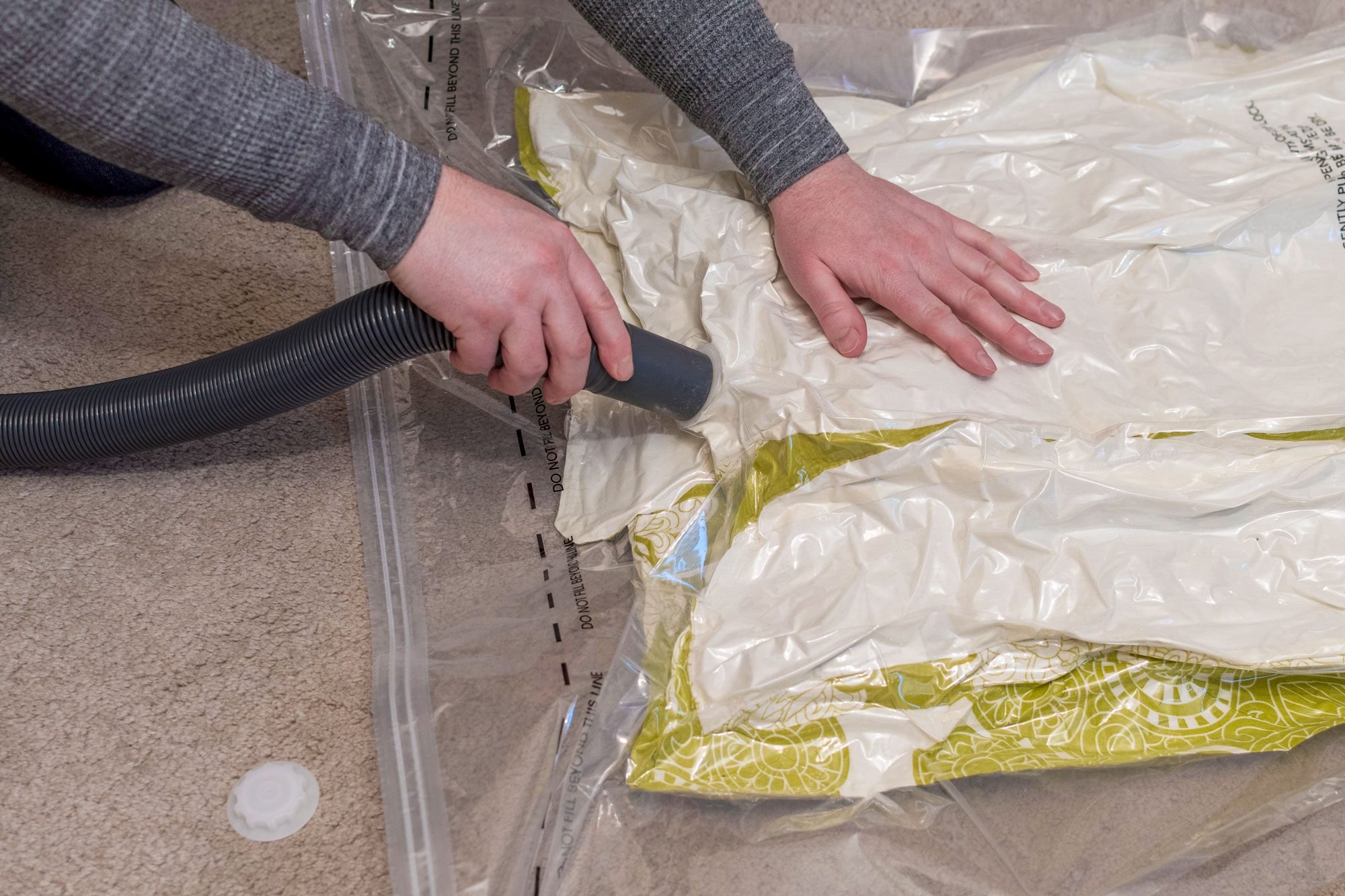 Using A Vacuum Storage Bag To Remove Air From Duvet