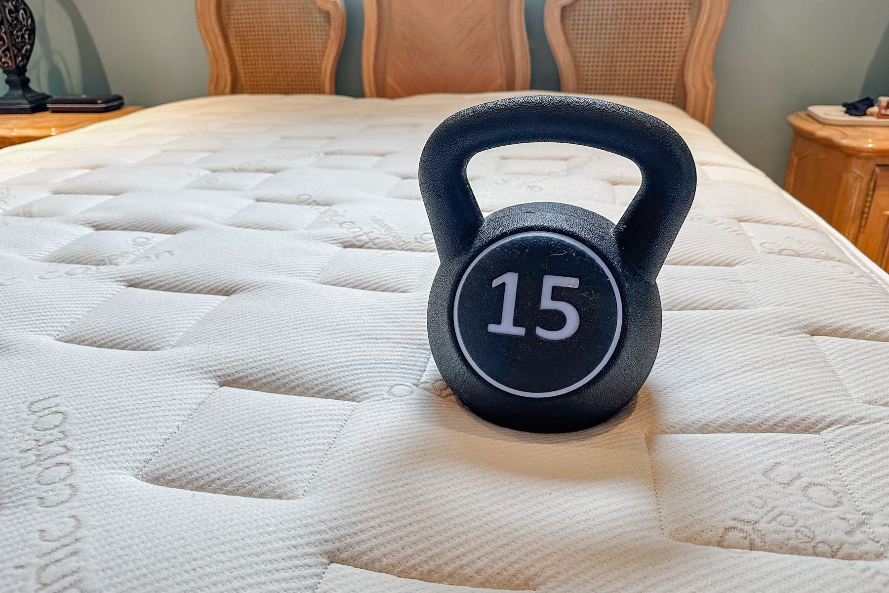 Naturepedic Eos Mattress with a kettlebell on it.