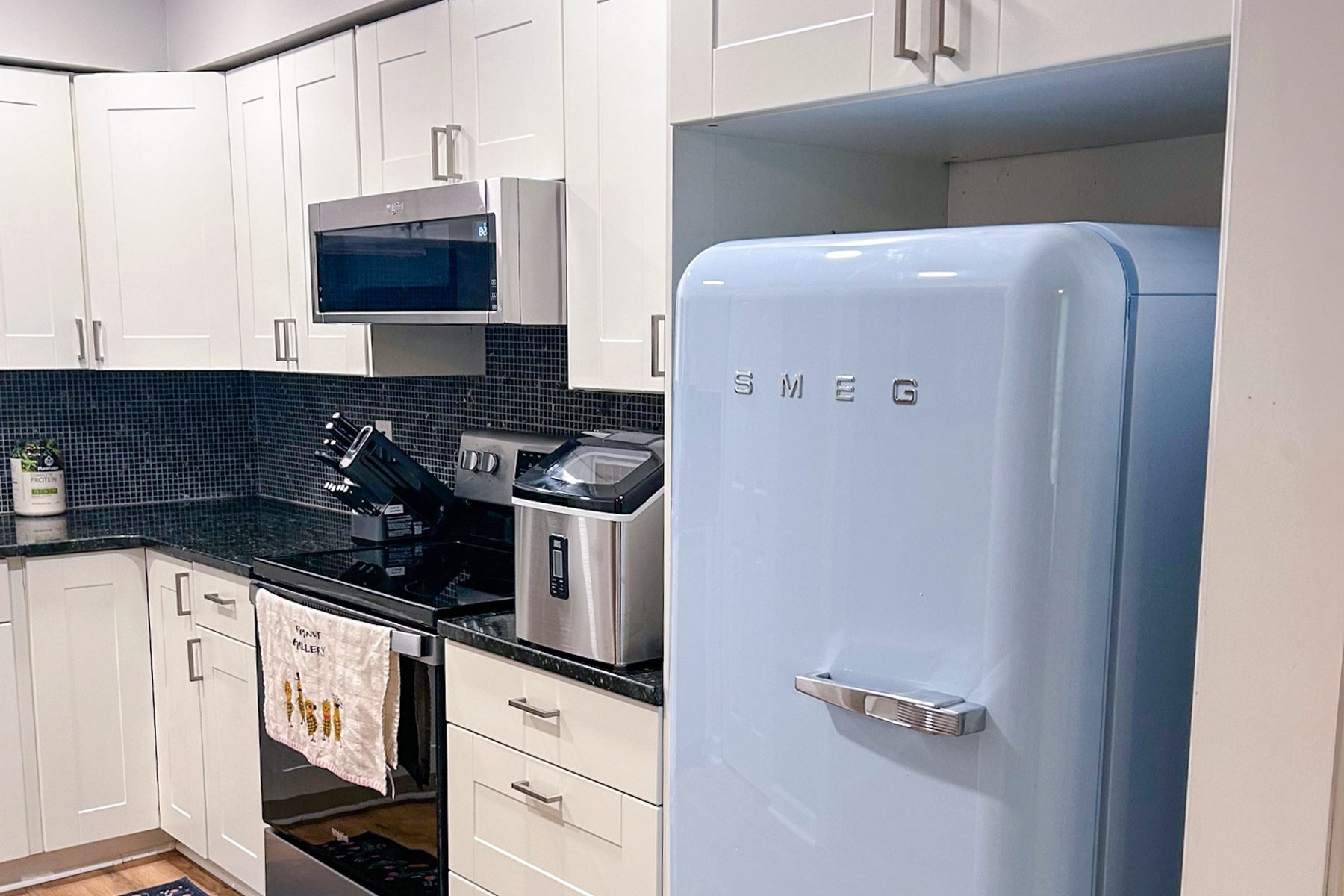 Smeg Fab 28 Fridge under the kitchen cabinet.