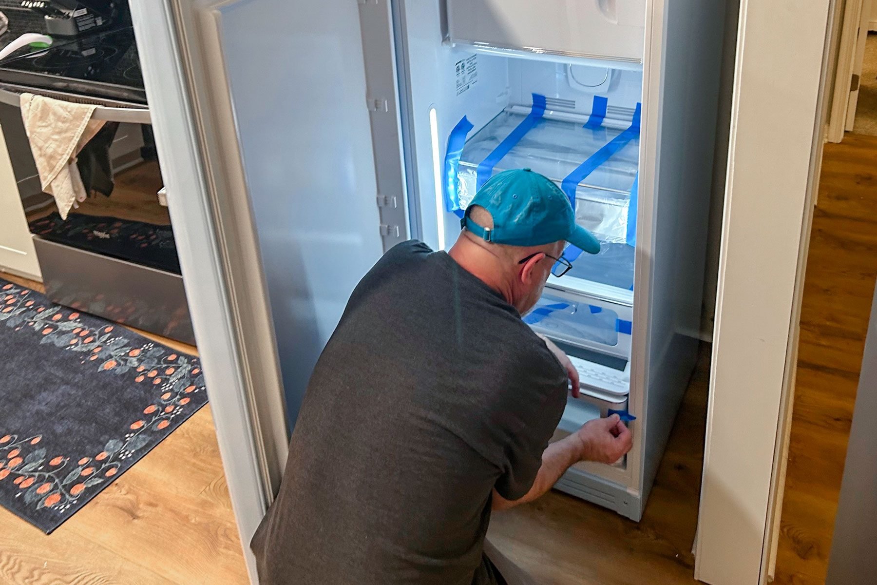 Man can be seen setting up the Smeg Fab 28 Fridge