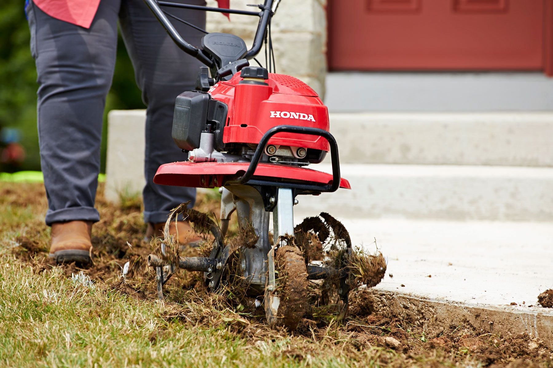 Tilling soil to remove weeds.